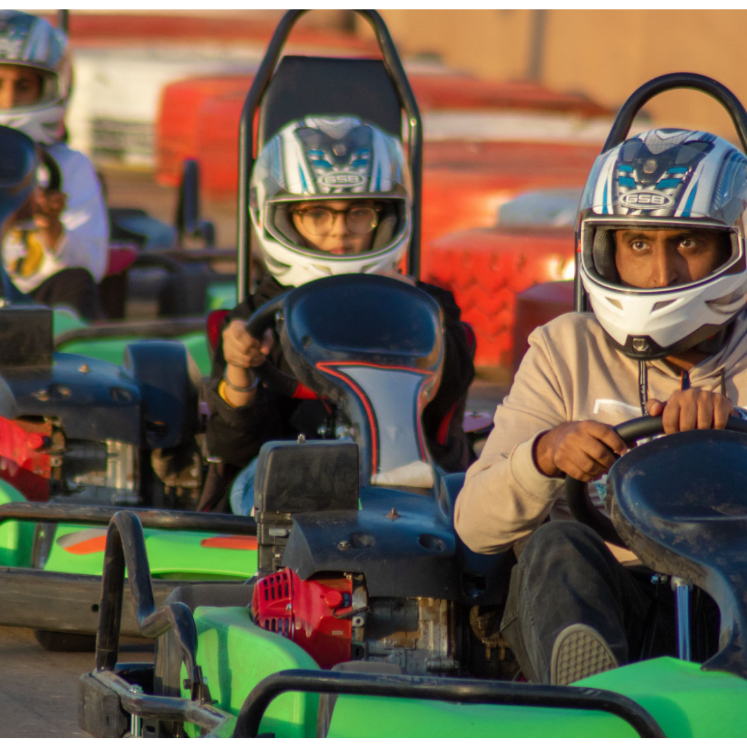 Close-up of several go-kart racers focused on the track.